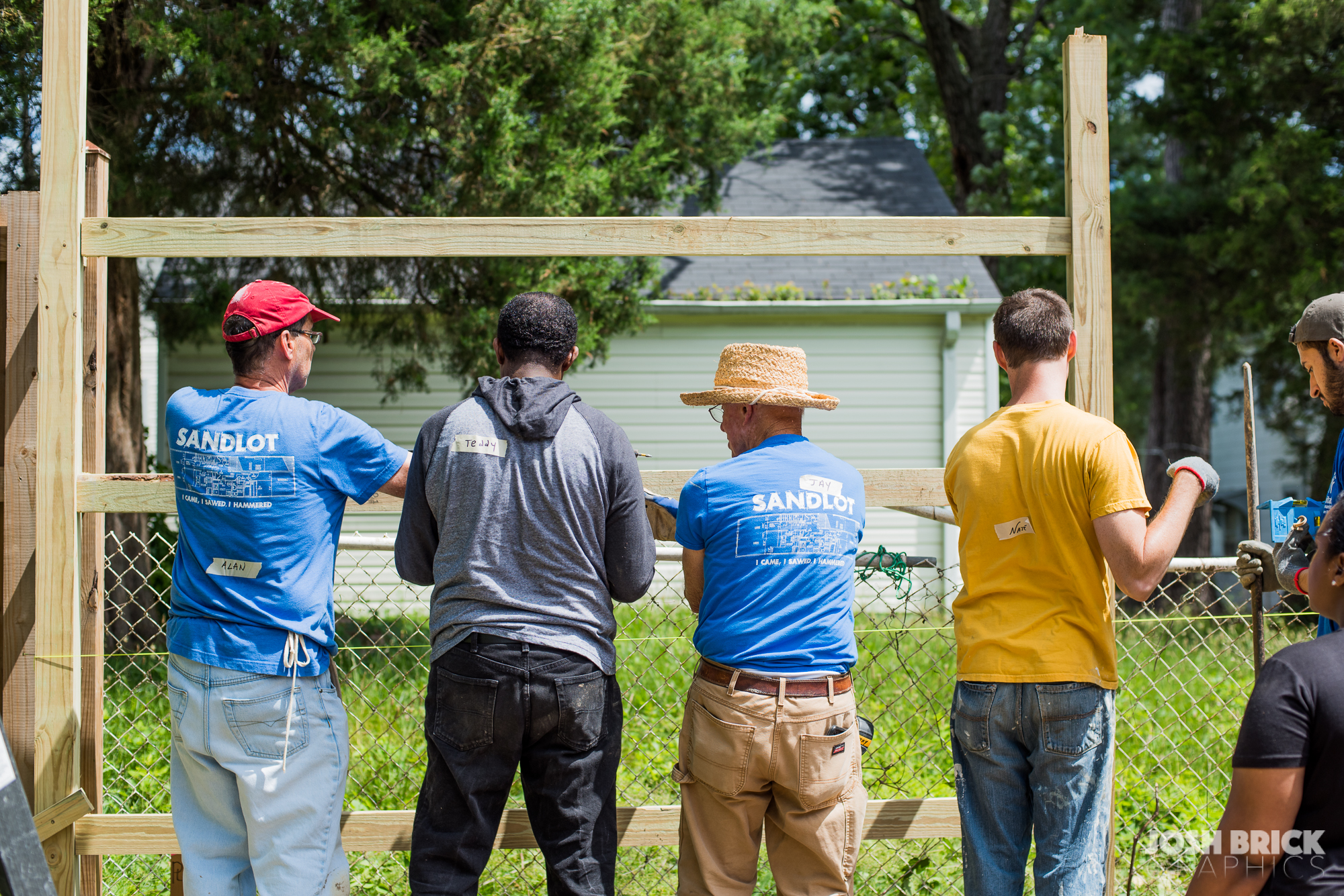 group of volunteers repairing a fence