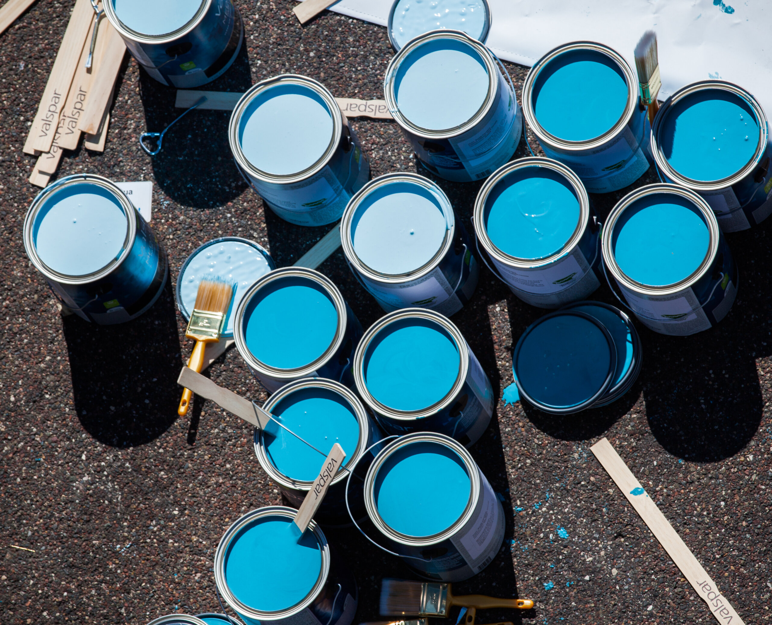 photos of blue paint cans on ground