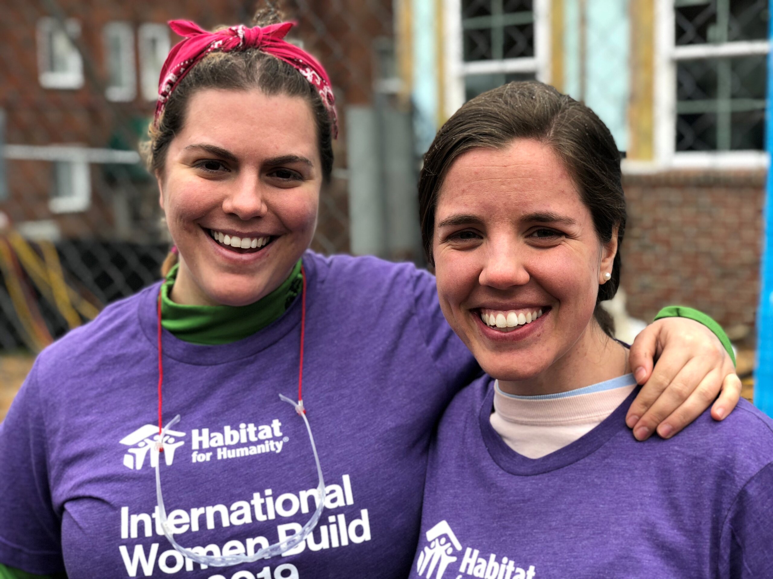 Two volunteers smiling at camera
