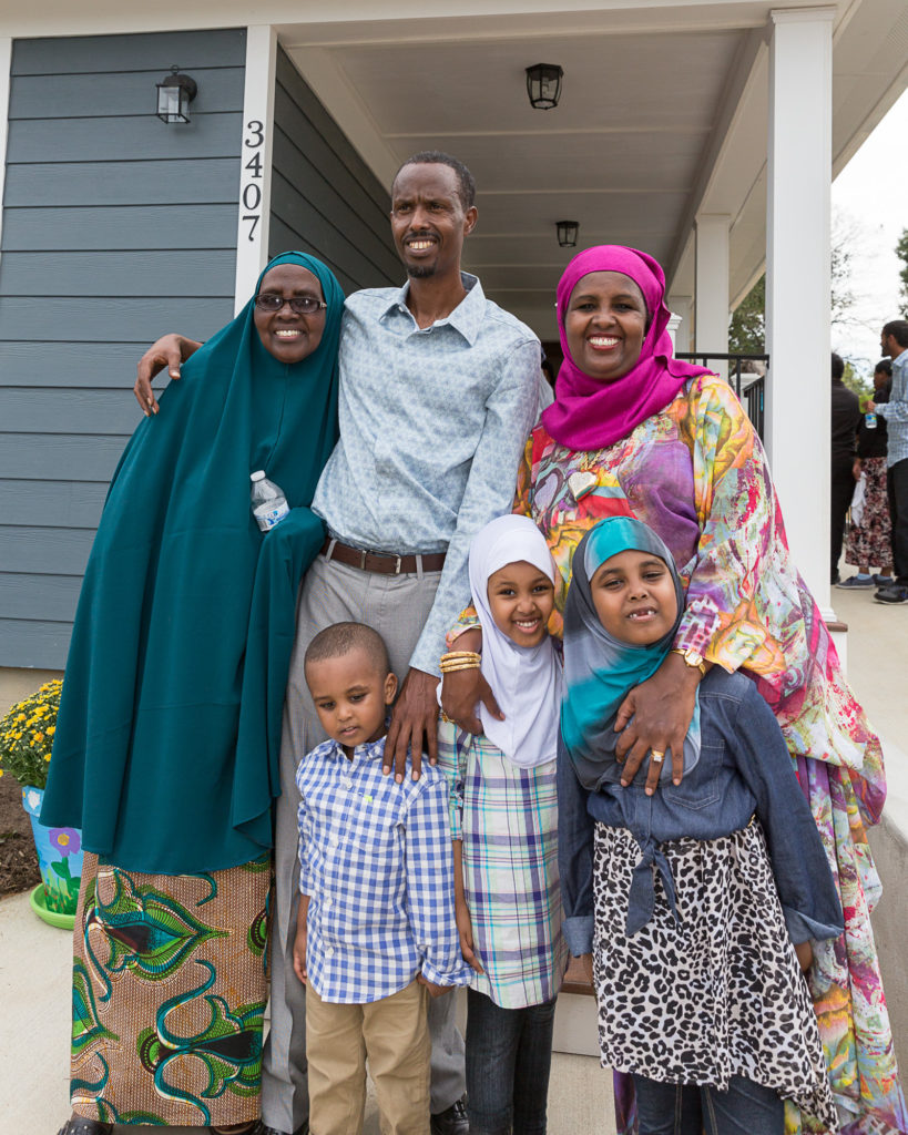 family in front of new home