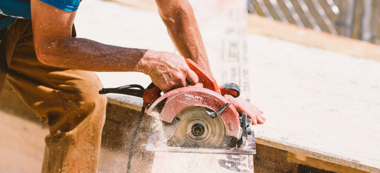 Person using power tool on a piece of wood